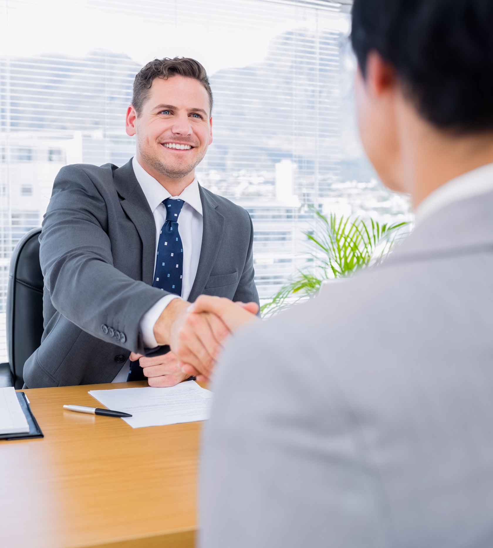 Professional business handshake in office setting